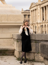 a lady in a lace patchwork velvet midi dress